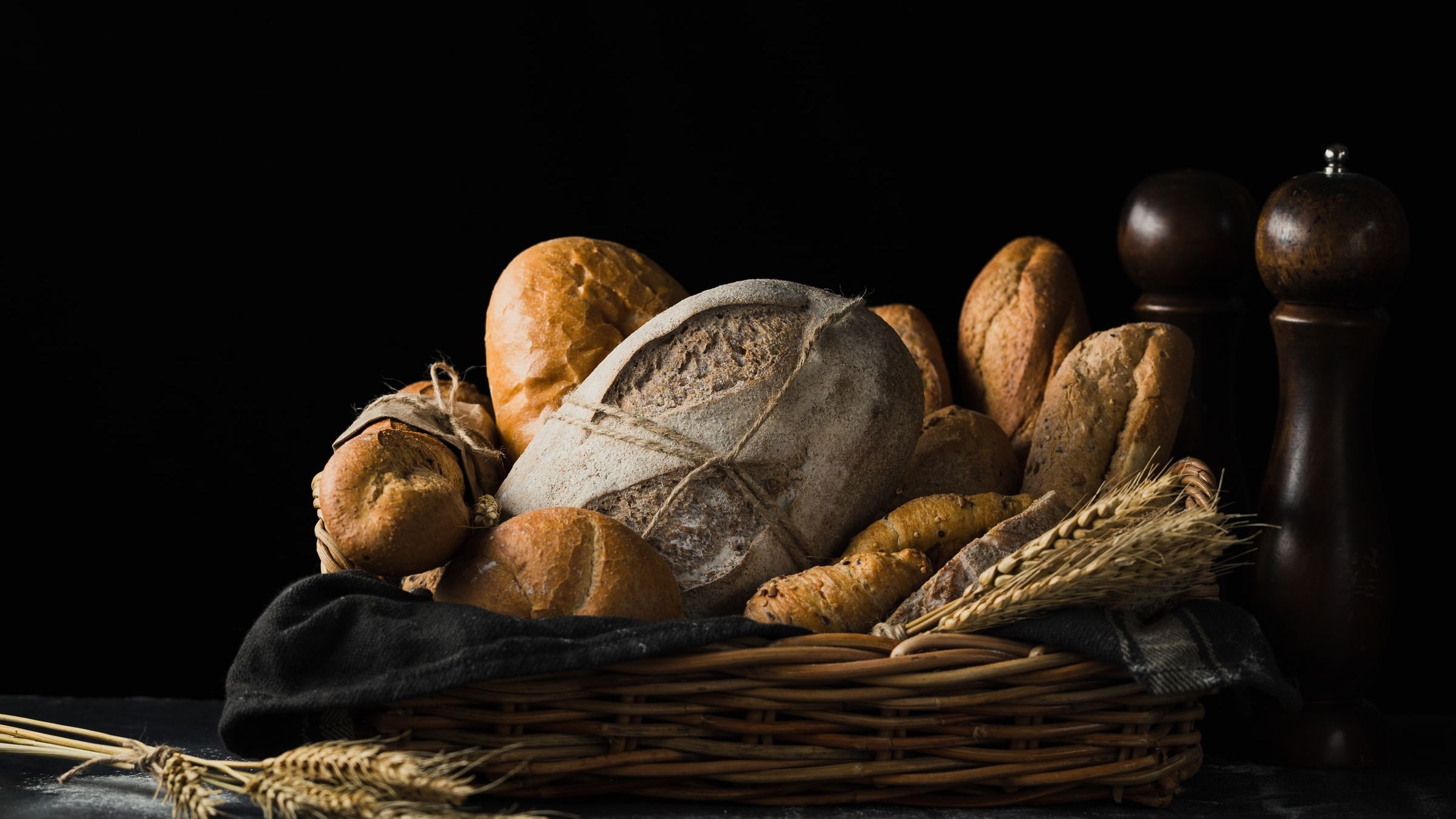 Bread in a basket on a table with dimmed background