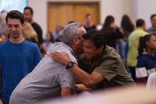 Two men are hugging for greeting.